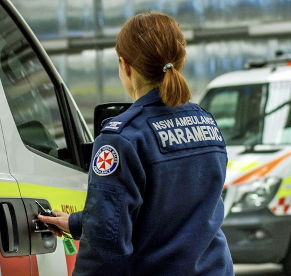 Woman getting into the NSW Ambulance vehicle